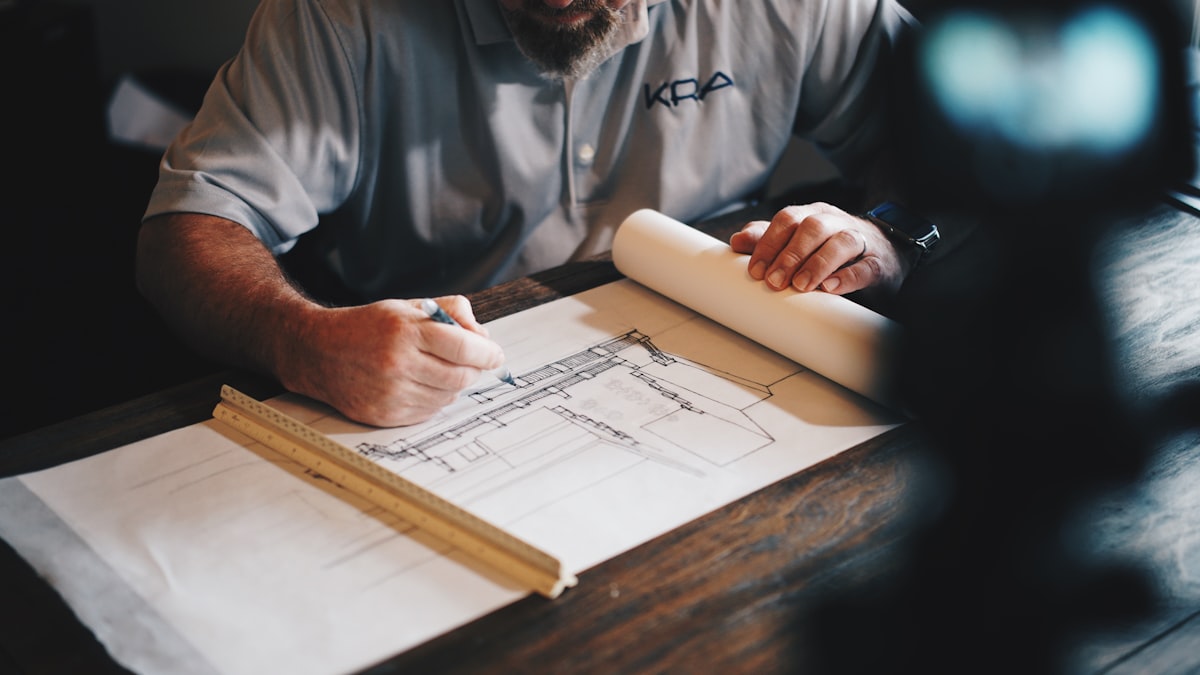 Best Laptops for Architecture Students in 2026 An architect working on a draft with a pencil and ruler