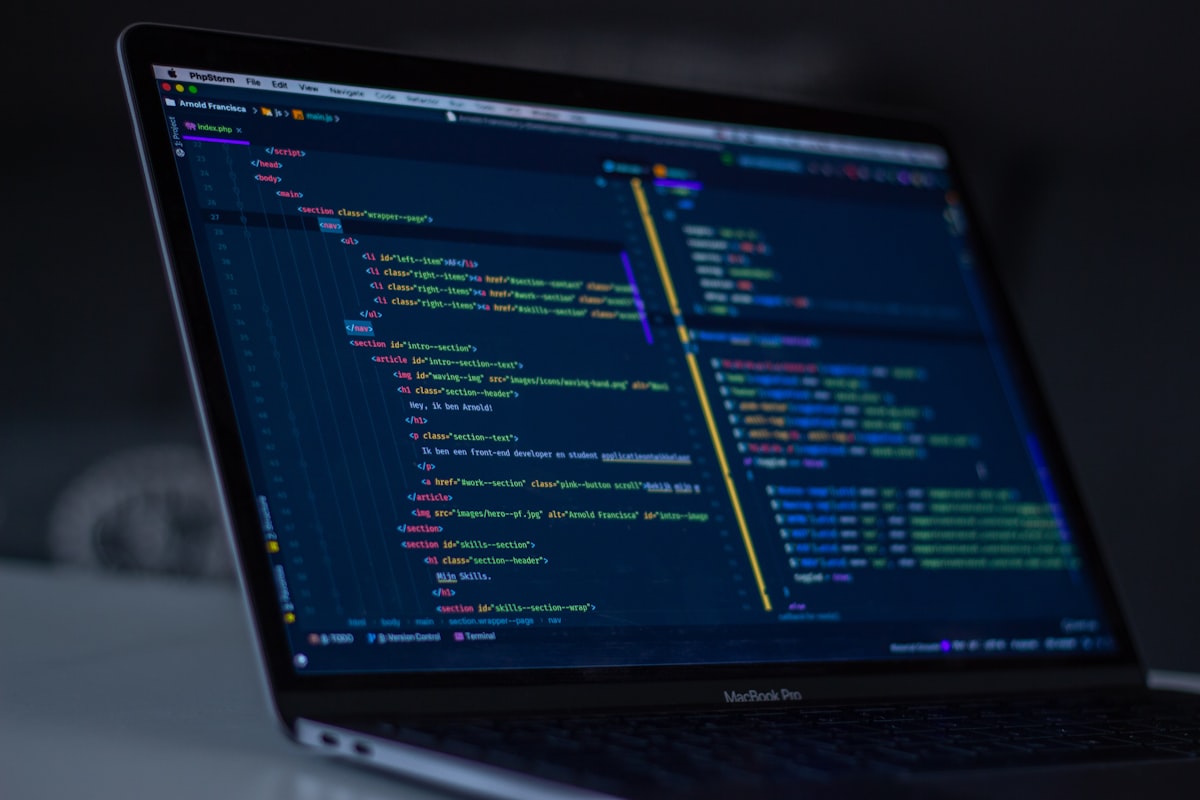 Best Laptops for Programming & Coding in 2026 A turned-on MacBook Pro displaying programming code