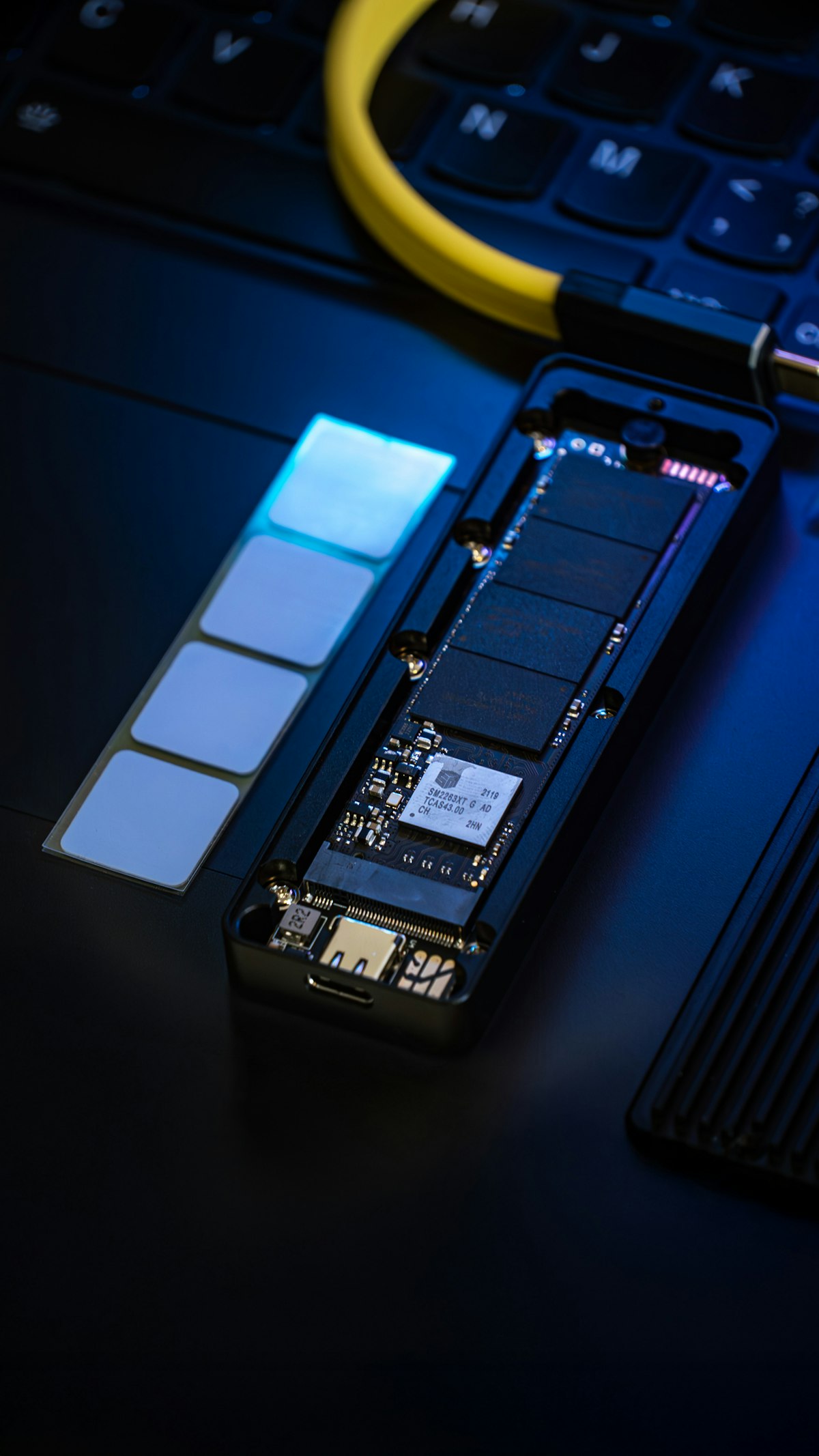 A disassembled SSD drive with memory chips and circuit board